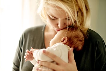 Women cradling baby