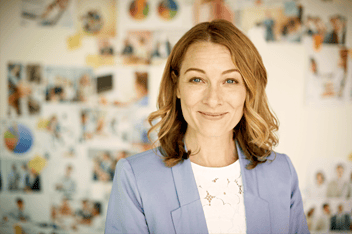 Woman stands in front of wall of images