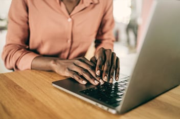 Woman sitting at desk using laptop
