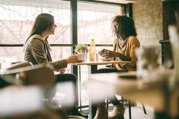 Two women talking at a coffee shop