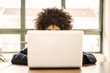 Woman sits in front of laptop
