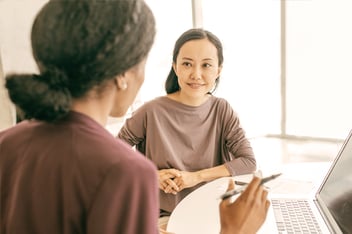 Two women having a discussion in a meeting