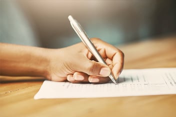 Woman filling out a checklist with pen