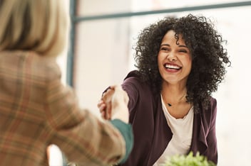 Woman shaking hands in job interview