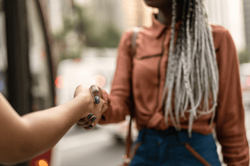 Close up of woman shaking hands outdoors