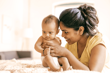 Woman playing with infant child