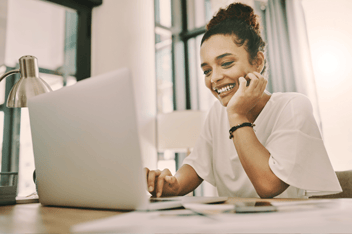 Woman smiling at laptop