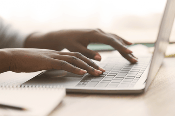 Woman typing on laptop keyboard