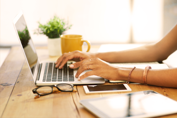 Photo of woman's hands at laptop